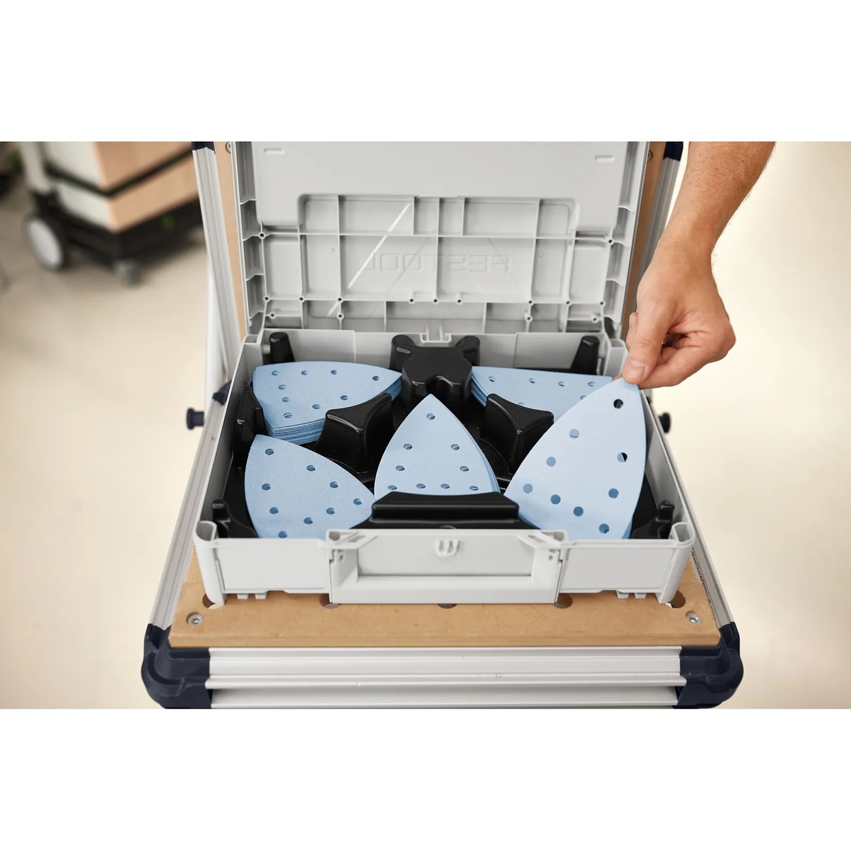 Festool 578195 Granat DTS/DTSC 400 Delta Abrasives 100-Piece Value Set Systainer3 opened on a work surface with sorted delta sanding sheets arranged by grit for fast selection in a workshop