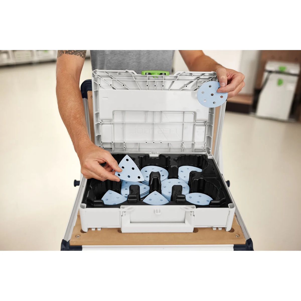 Festool 578196 Granat RO 90 / DX93 Abrasives D90 / V93 160-Piece Value Set Systainer3 opened on a work surface with round and delta sanding abrasives organized by compartment for quick grit changes in a shop setting
