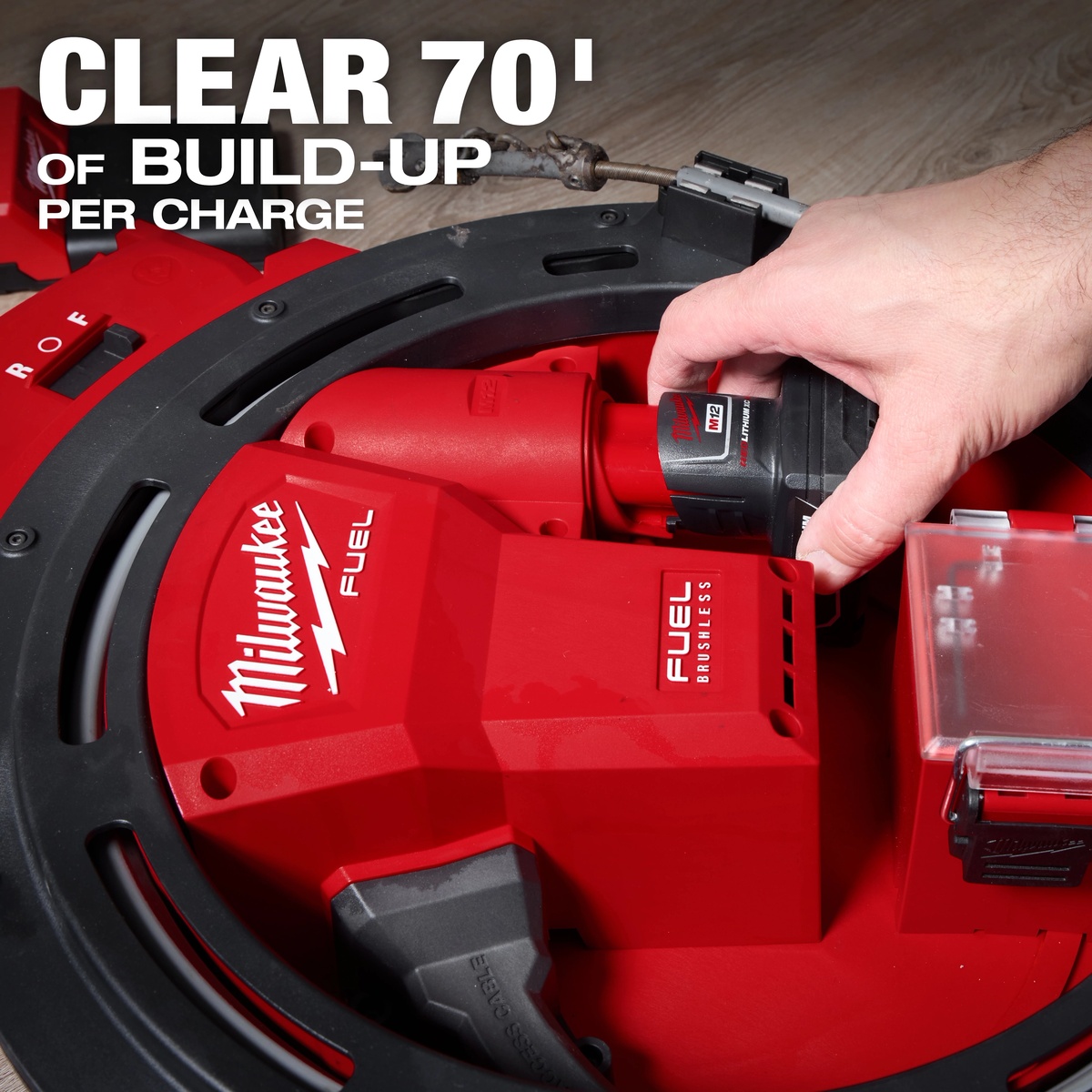 Milwaukee 2519-21 M12 FUEL High Speed Chain Snake showing the installed M12 battery inside the drum housing for cordless pipe cleaning