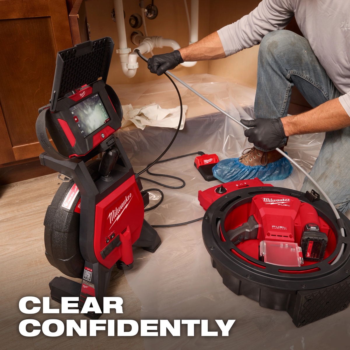 Milwaukee 2519-21 M12 FUEL High Speed Chain Snake used with inspection equipment during indoor drain cleaning service for a sink line