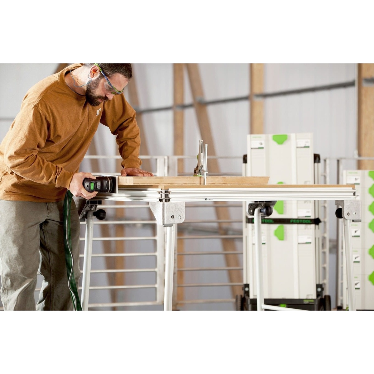 Festool RTS 400 REQ Orbital Sander Set w/ Granat Abrasive Value Set Systainer in use on a wood workpiece with dust hose connected in a workshop