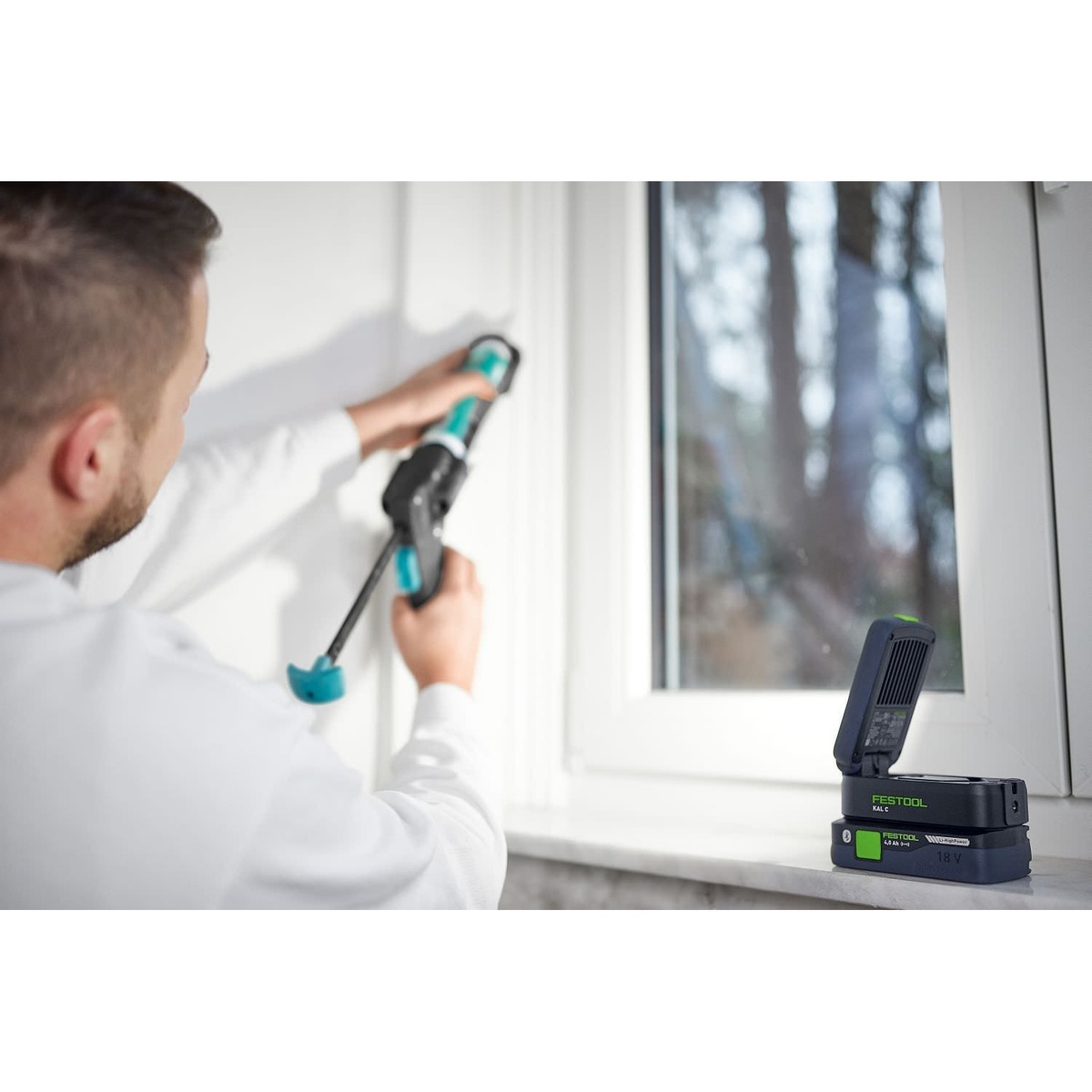 Festool SYSLITE KAL C Cordless 1200-Lumen Task Light with SYSLITE Magnetic Mounting Head lighting a window-side work area during interior finish work