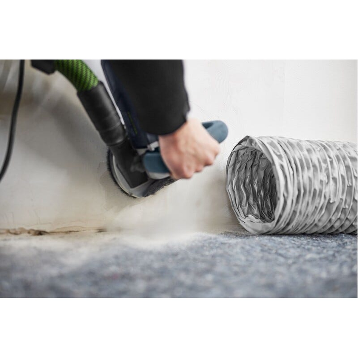 Festool SYS-AIR HEPA Air Filter with LS-SYS-AIR 7-3/4-in. Diameter x 19-1/2-ft. Air Supply Hose drawing airborne dust away from a wall sanding task in an indoor renovation room