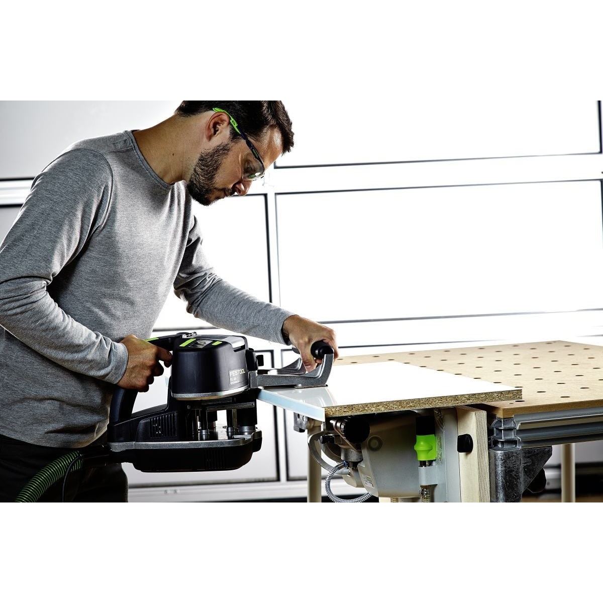 Festool 574616 Conturo KA 65 Edge Bander Deluxe Master Set applying edge banding to a panel on a Festool worktable during cabinet work