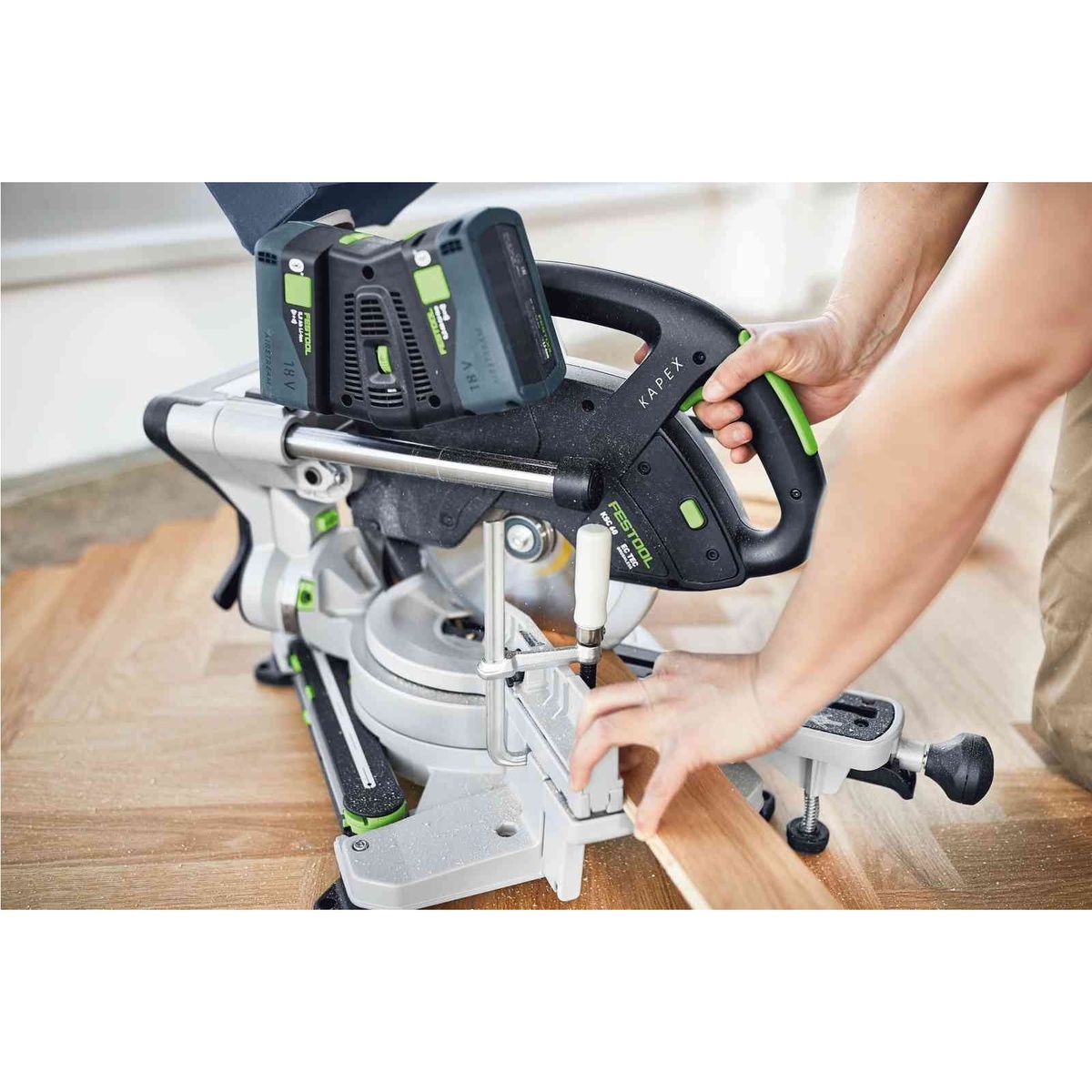 Festool 577176 Kapex KSC 60 EB Cordless Dual-18V Miter Saw 5.0 Kit making a controlled clamped cut in interior wood flooring and trim material
