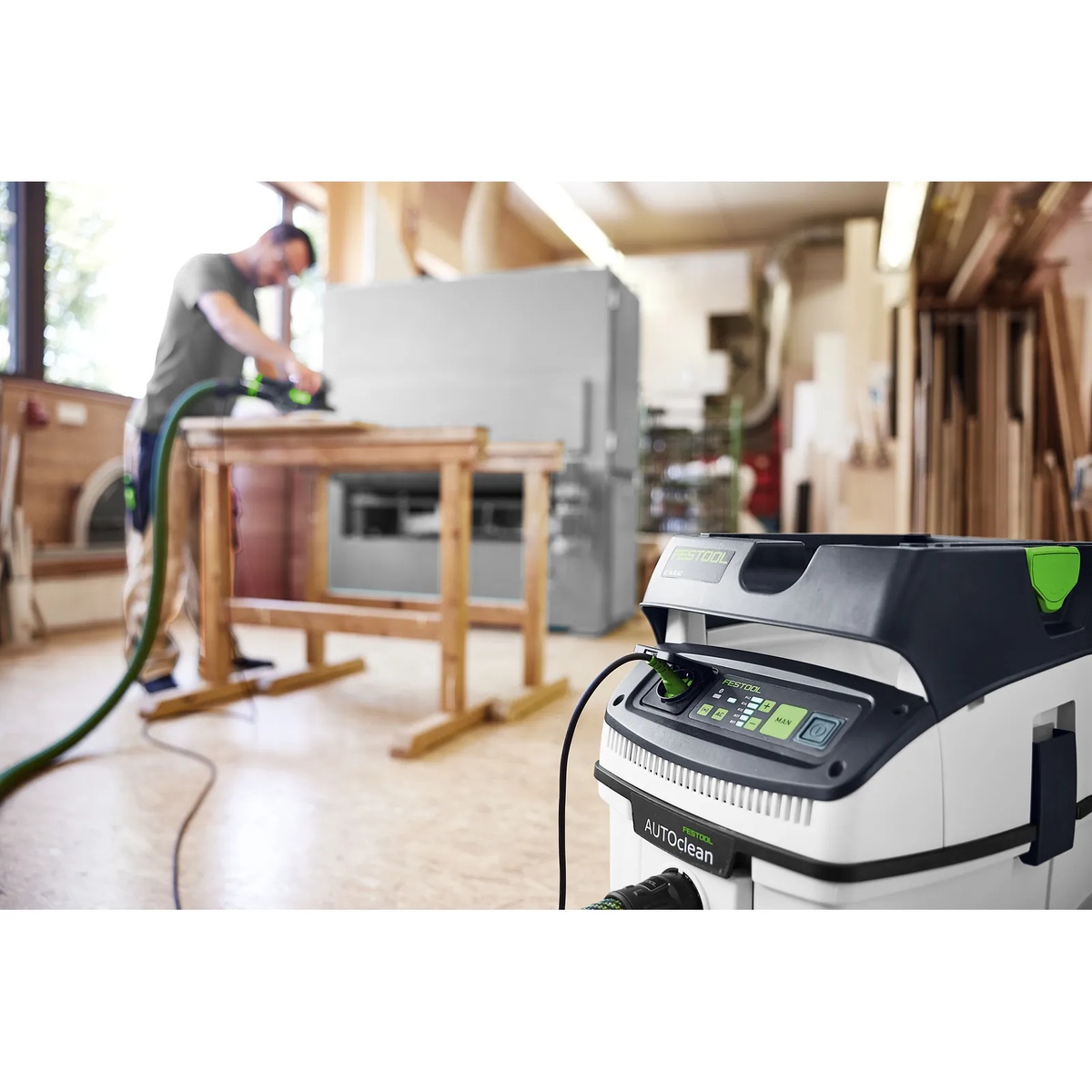 Close-up of the Festool dust extractor control panel in a woodworking shop while connected to a sanding setup