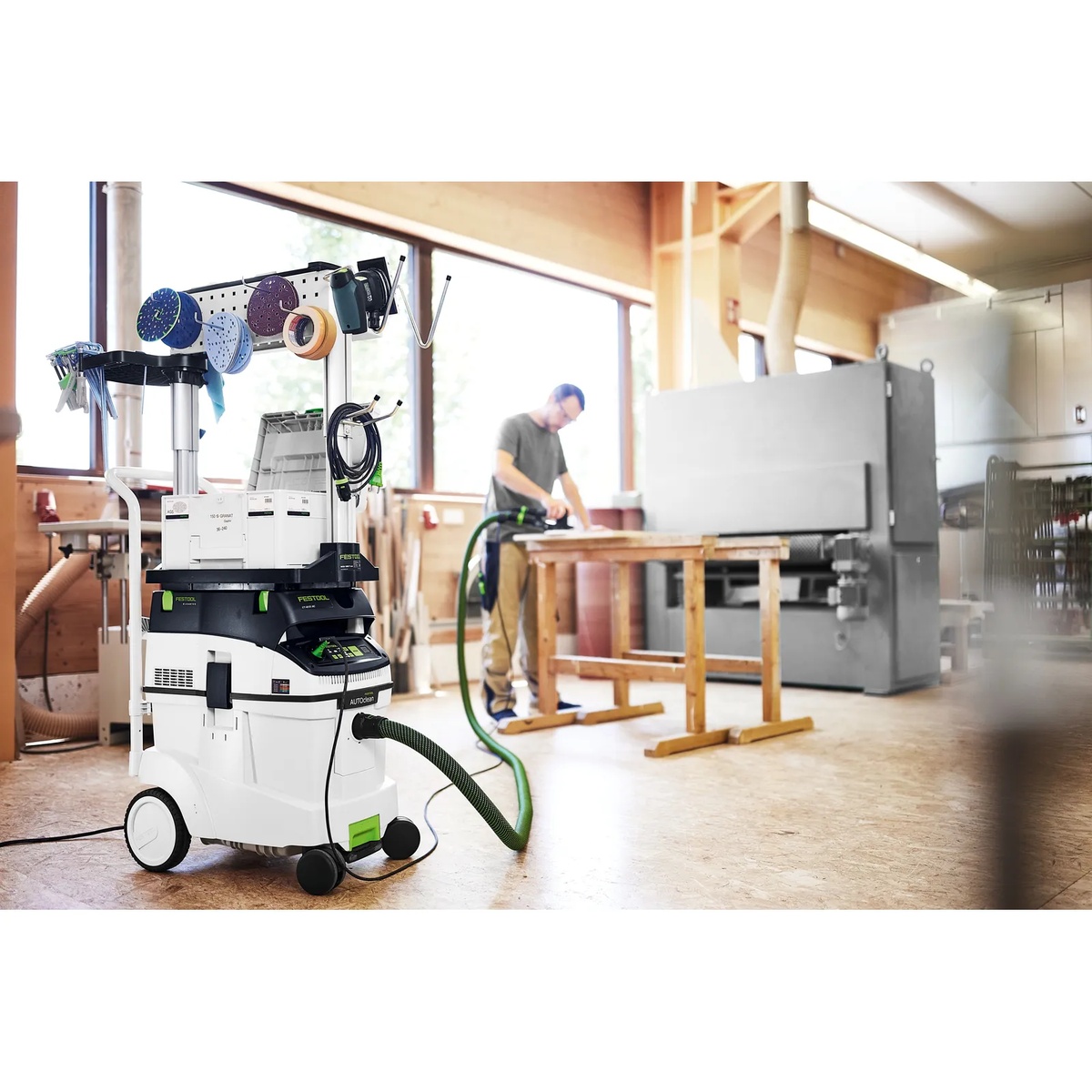 Festool 577876 Dust Extractor CLEANTEC CT 48 EI AC HEPA in a woodworking shop connected to a sanding setup for real-time dust extraction during bench work