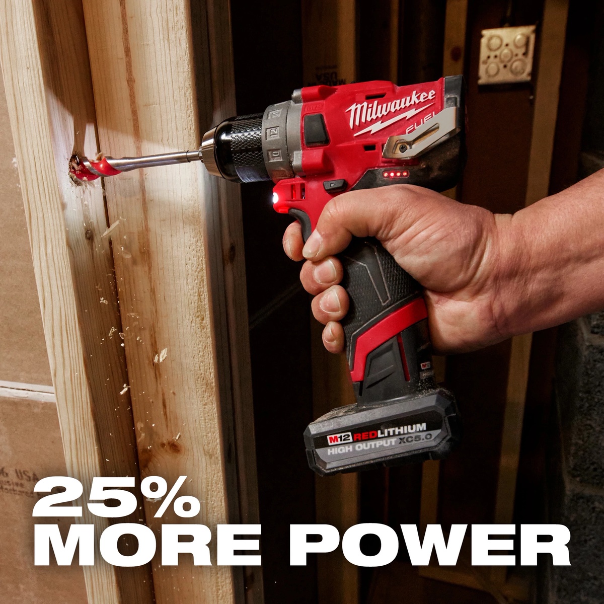 Milwaukee M12 REDLITHIUM HIGH OUTPUT XC5.0 Battery Pack powering an M12 drill driver while boring into framing lumber on a jobsite