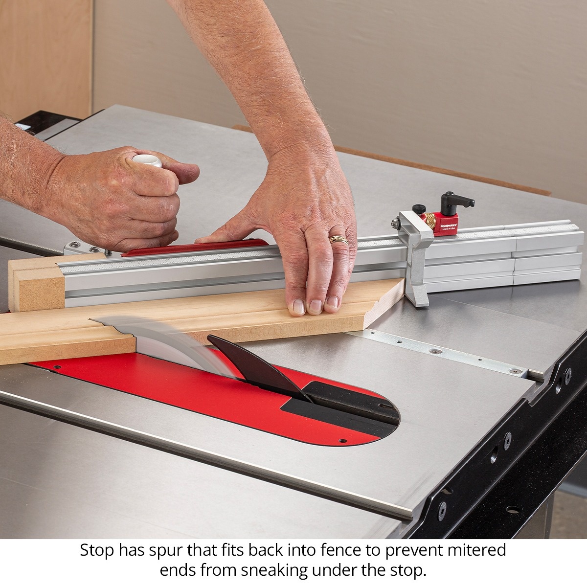 Woodpeckers Flip Stop for the in-DEXABLE Miter Gauge supporting a mitered molding cut on a table saw fence in a woodworking application