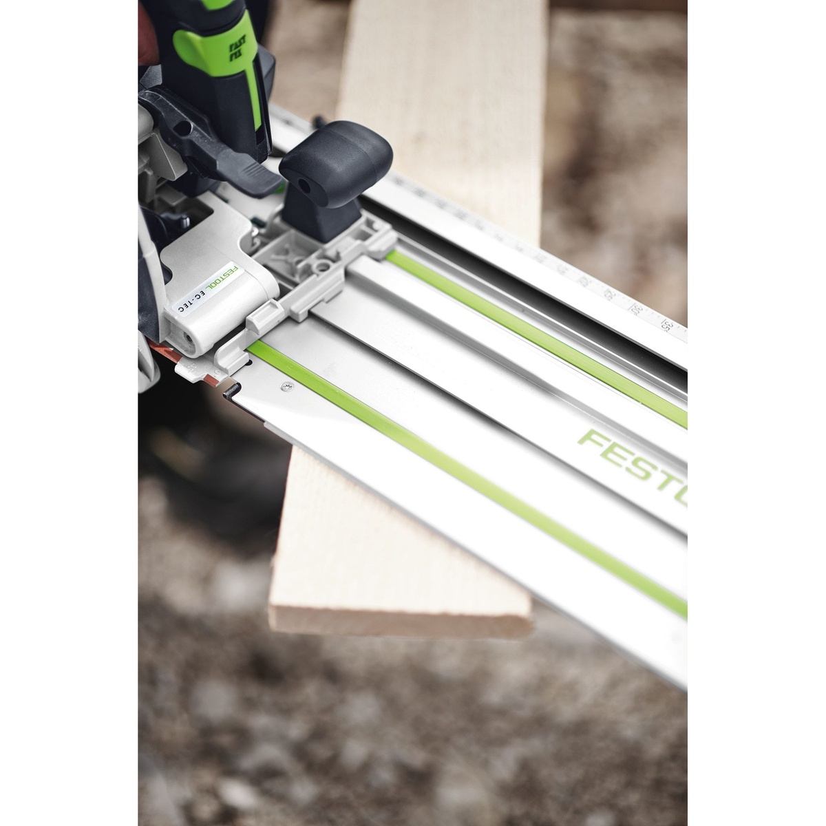 Festool 576173 HKC 55 Cordless Bluetooth 5.2Ah Track Saw PLUS-FSK connected to FSK guide rail for repeat crosscuts on a wood board outdoors