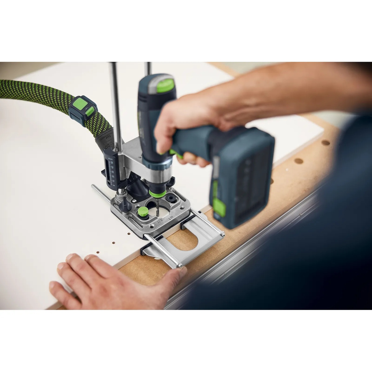 Festool MB 40 Mobile Drilling Attachment Set drilling a straight hole in a cabinet panel with dust extraction connected during furniture and installation work