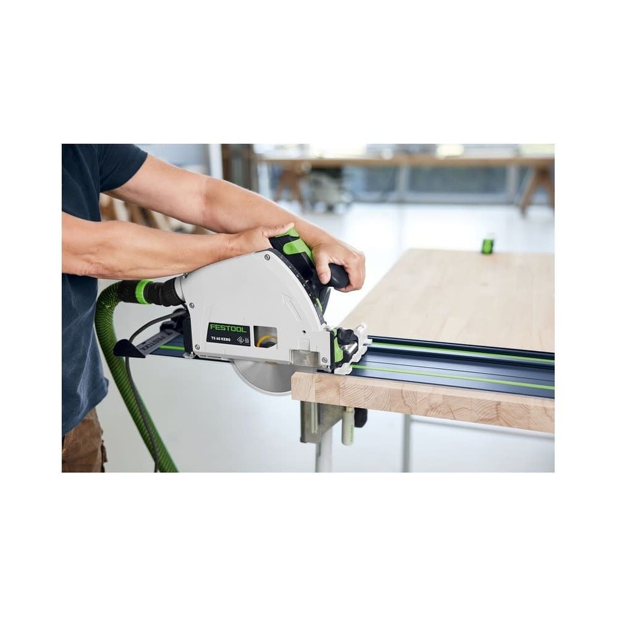 Festool 578246 FS 1400 Limited Edition 100th Anniversary Blue Anodized 55 inch Guide Rail guiding a track saw through a wood panel on a worktable for straight, splinter-free cutting