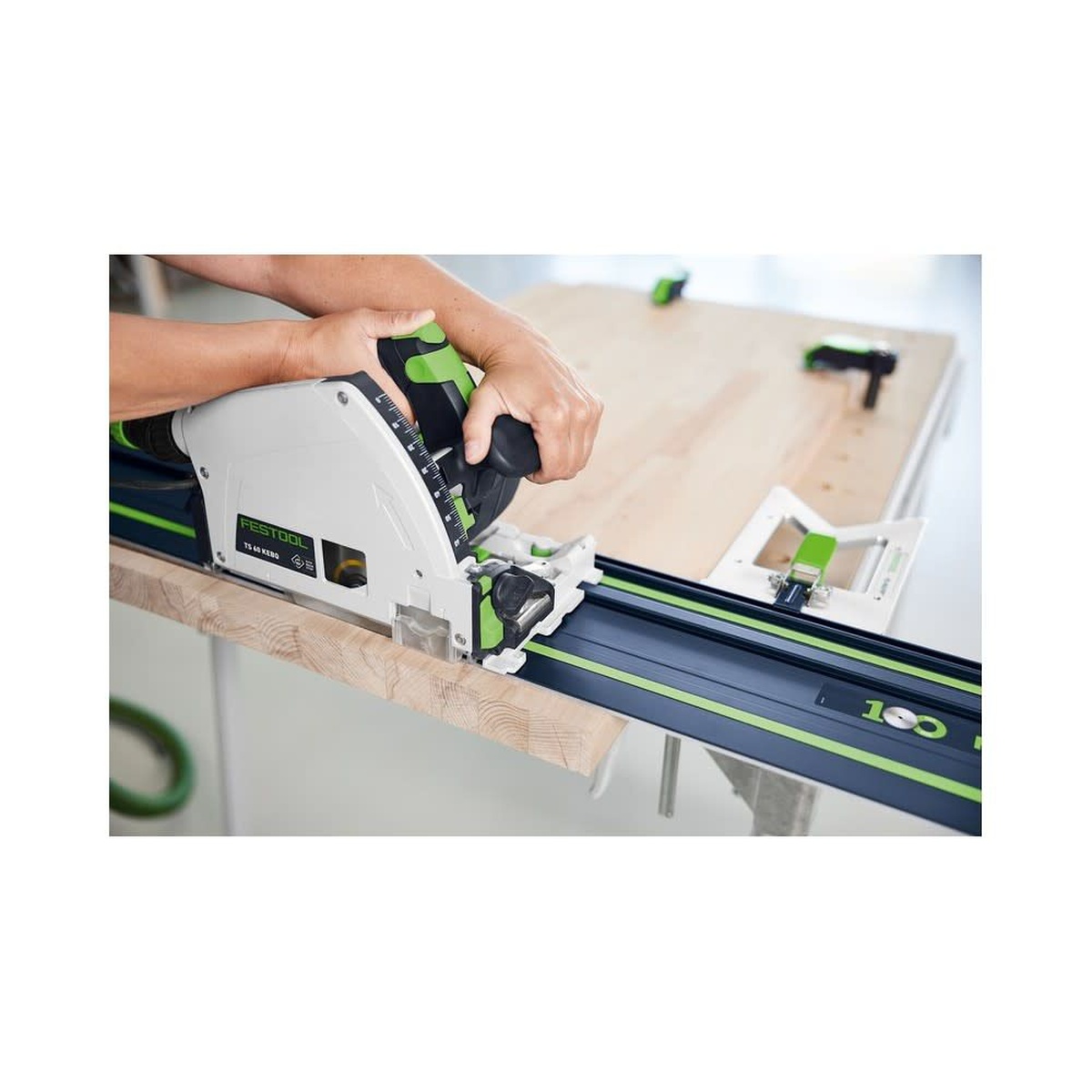 Festool 578246 FS 1400 Limited Edition 100th Anniversary Blue Anodized 55 inch Guide Rail in use on a wood workpiece with a track saw during jobsite-style cutting setup