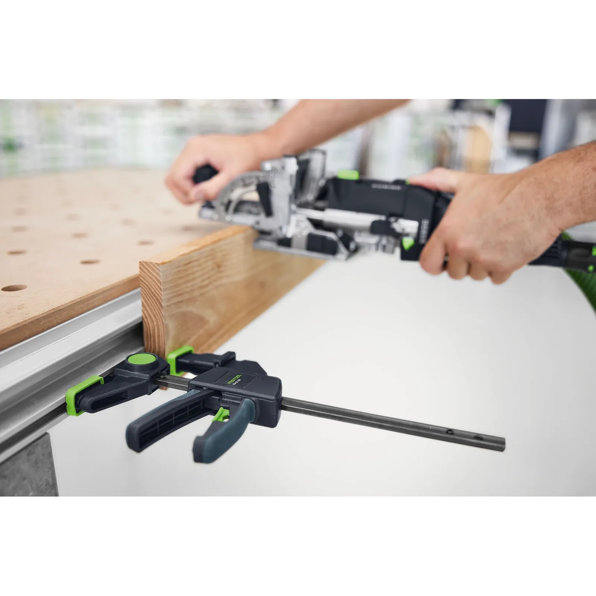 Festool FS-EZ 150/2 One-Handed Clamp securing a guide rail on an MFT work table while cutting a wood workpiece in a shop setup