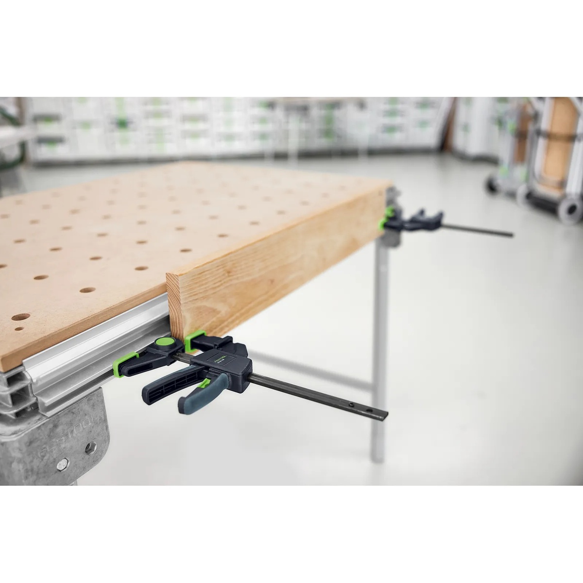 Festool FS-EZ 150/2 One-Handed Clamp locked into the groove of an MFT work table holding a wood board for precise positioning