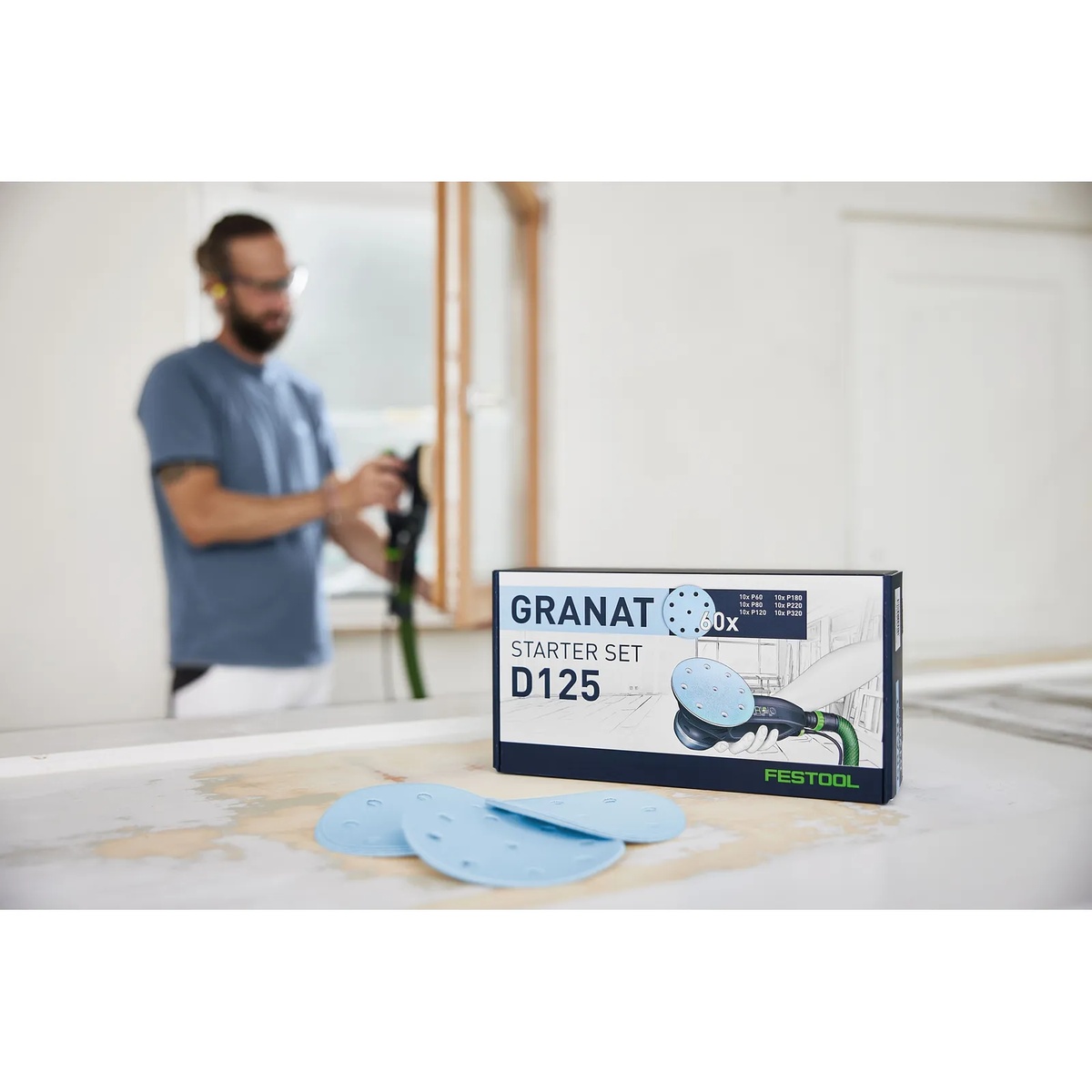 Festool D125 GR-Set 5 Inch Multi-Grit Sanding Disc Starter Set on a workbench with discs laid out for surface preparation in a finish room