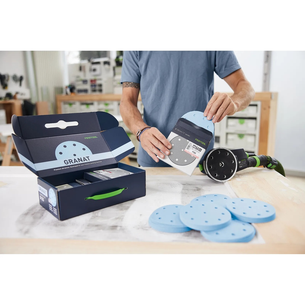 Festool D125 GR-Set 5 inch Granat sanding discs and packaging beside a Festool sander during finish sanding setup on a bench