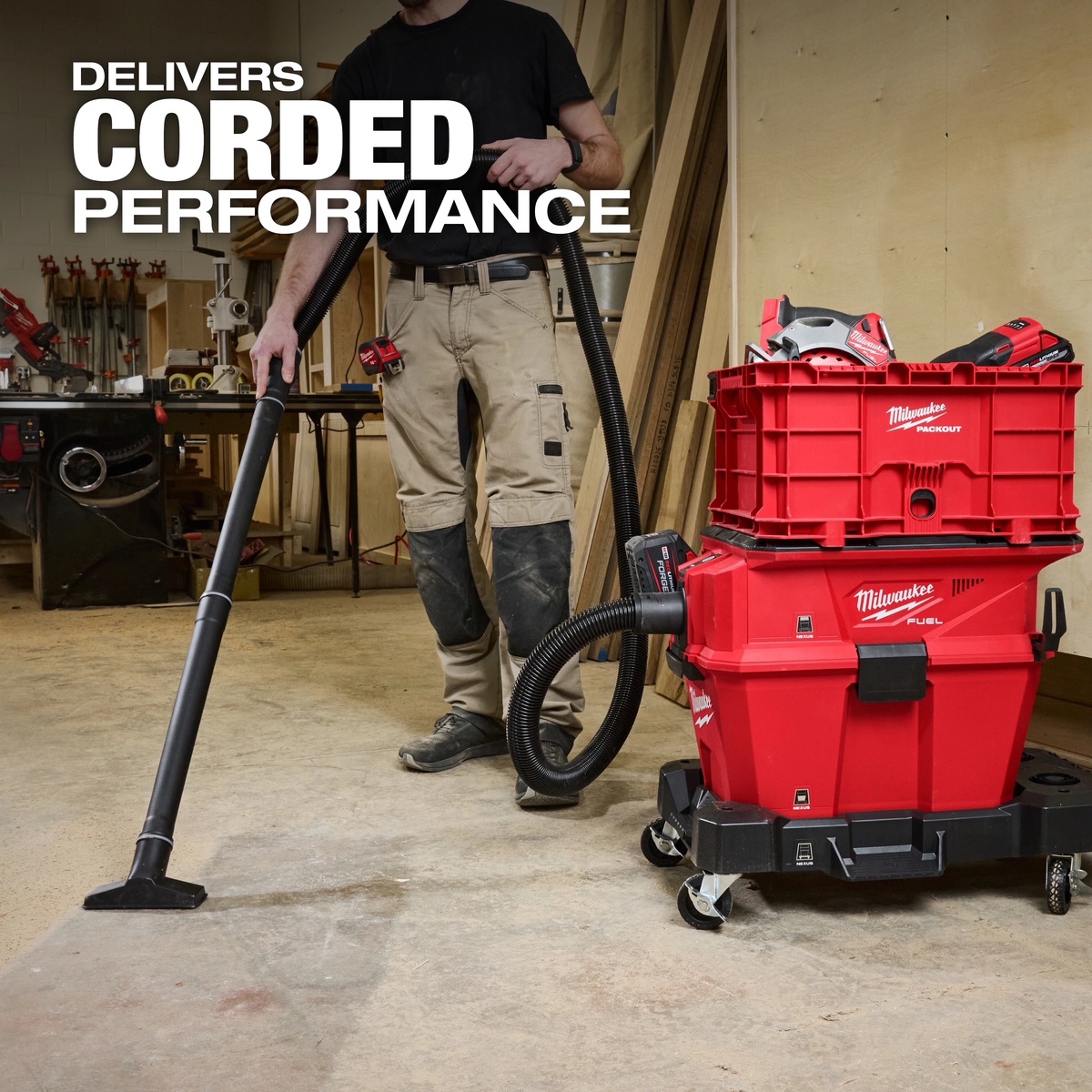 Milwaukee 0915-20 M18 FUEL NEXUS 6 Gallon Wet/Dry Vacuum w/ PACKOUT Compatibility cleaning a workshop floor with hose and floor nozzle during indoor jobsite cleanup