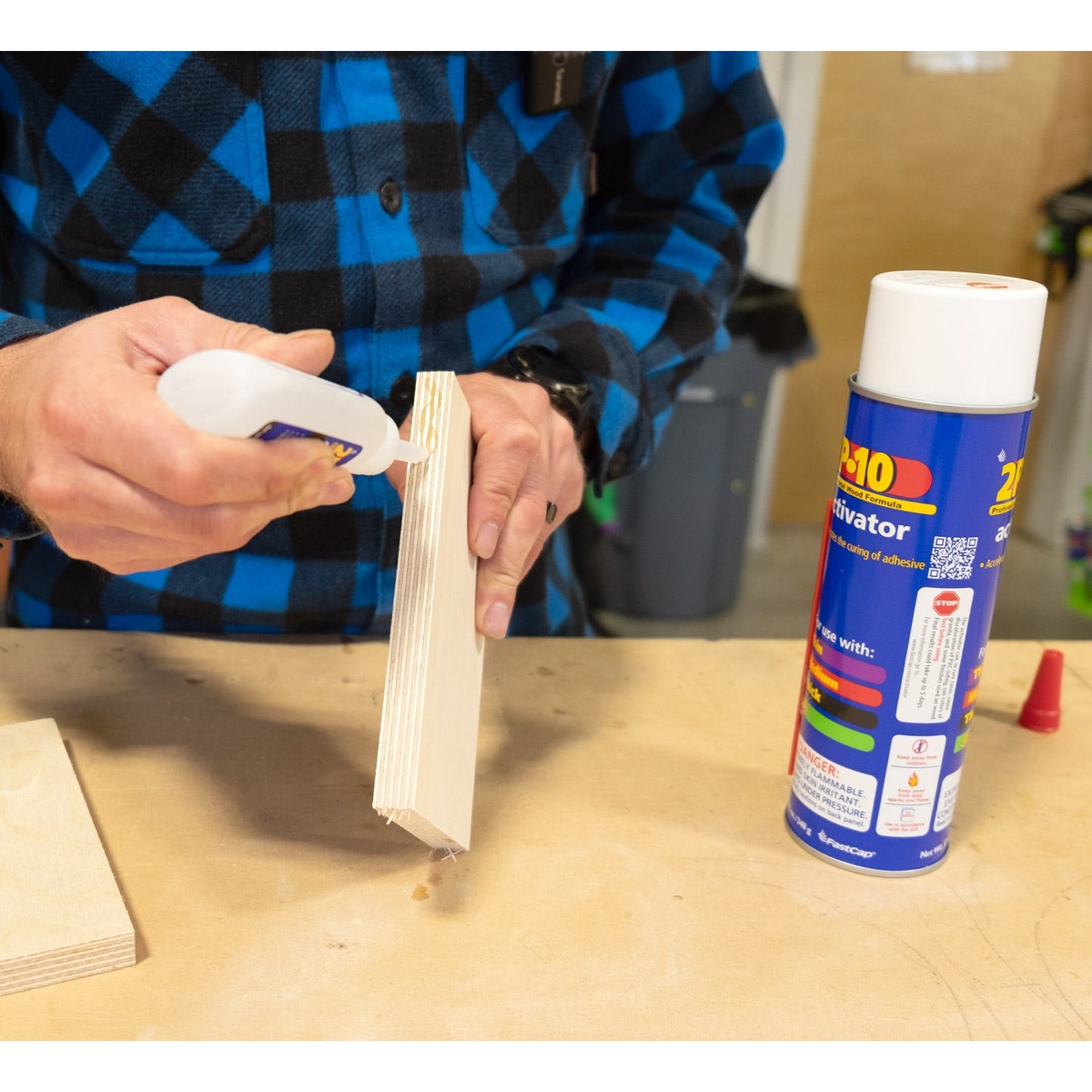 Fastcap 2P-10 Solo Kit thick adhesive applied along the edge of plywood for controlled woodworking glue placement at a bench