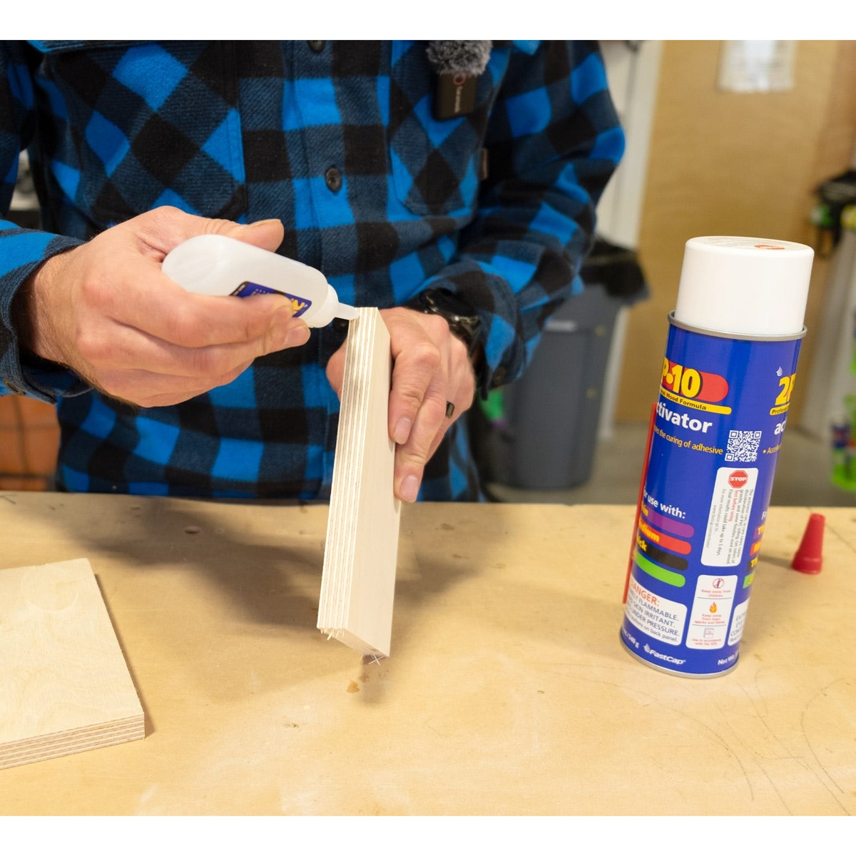 Fastcap 2P-10 Solo Kit 2-oz. Thick Adhesive and 12-oz. Activator Bundle being used to bond plywood panels on a workbench during woodworking assembly