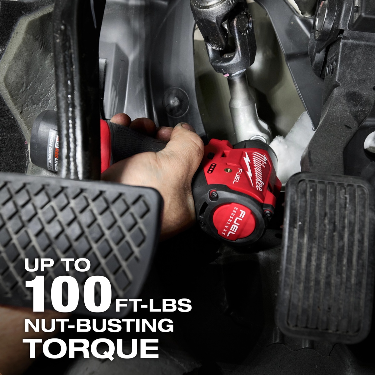 Milwaukee 3048-20 M12 FUEL 1/4 inch subcompact impact wrench driving a fastener in a confined interior vehicle mounting point