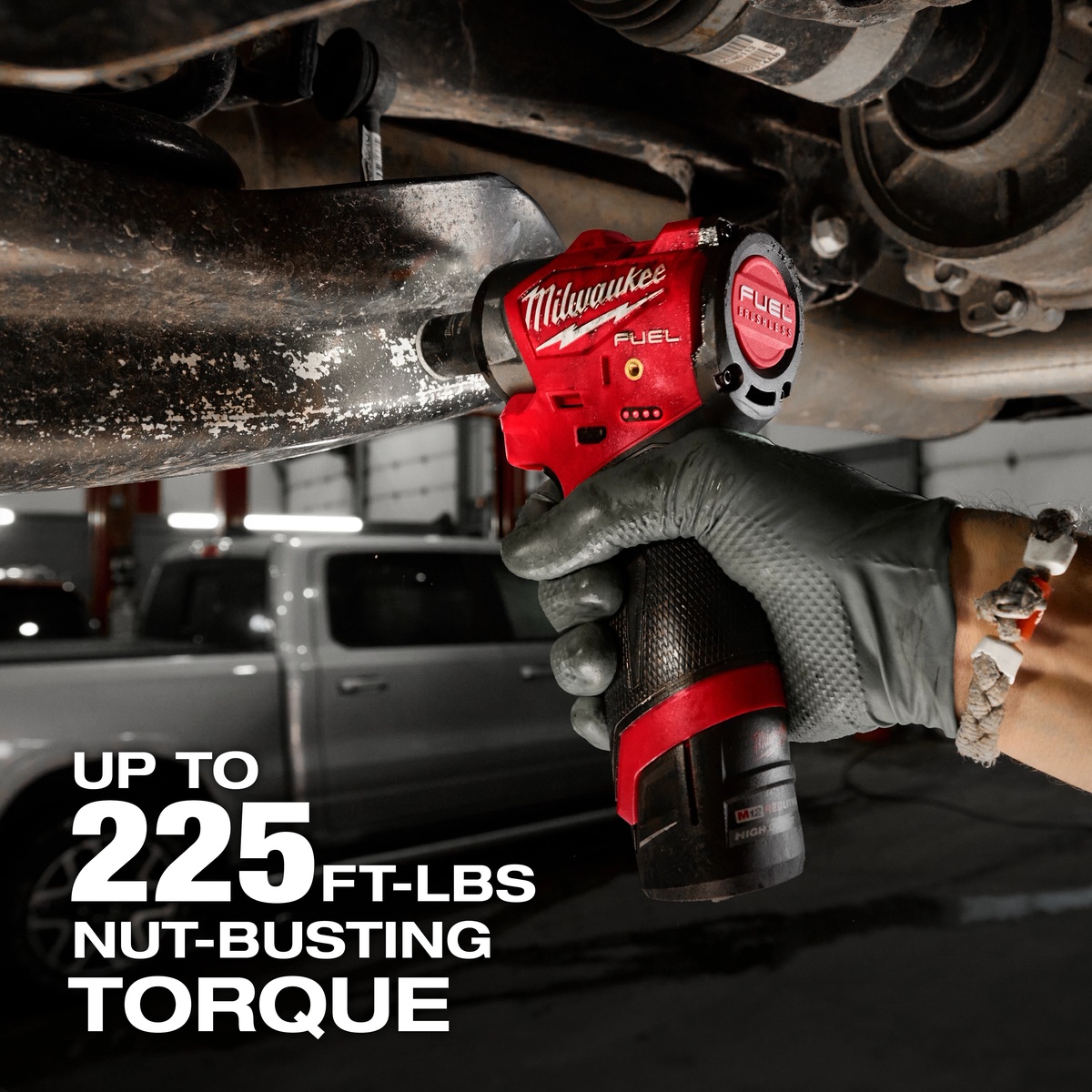 Milwaukee M12 FUEL 3/8 inch Subcompact Impact Wrench w/ Friction Ring loosening an automotive fastener underneath a vehicle