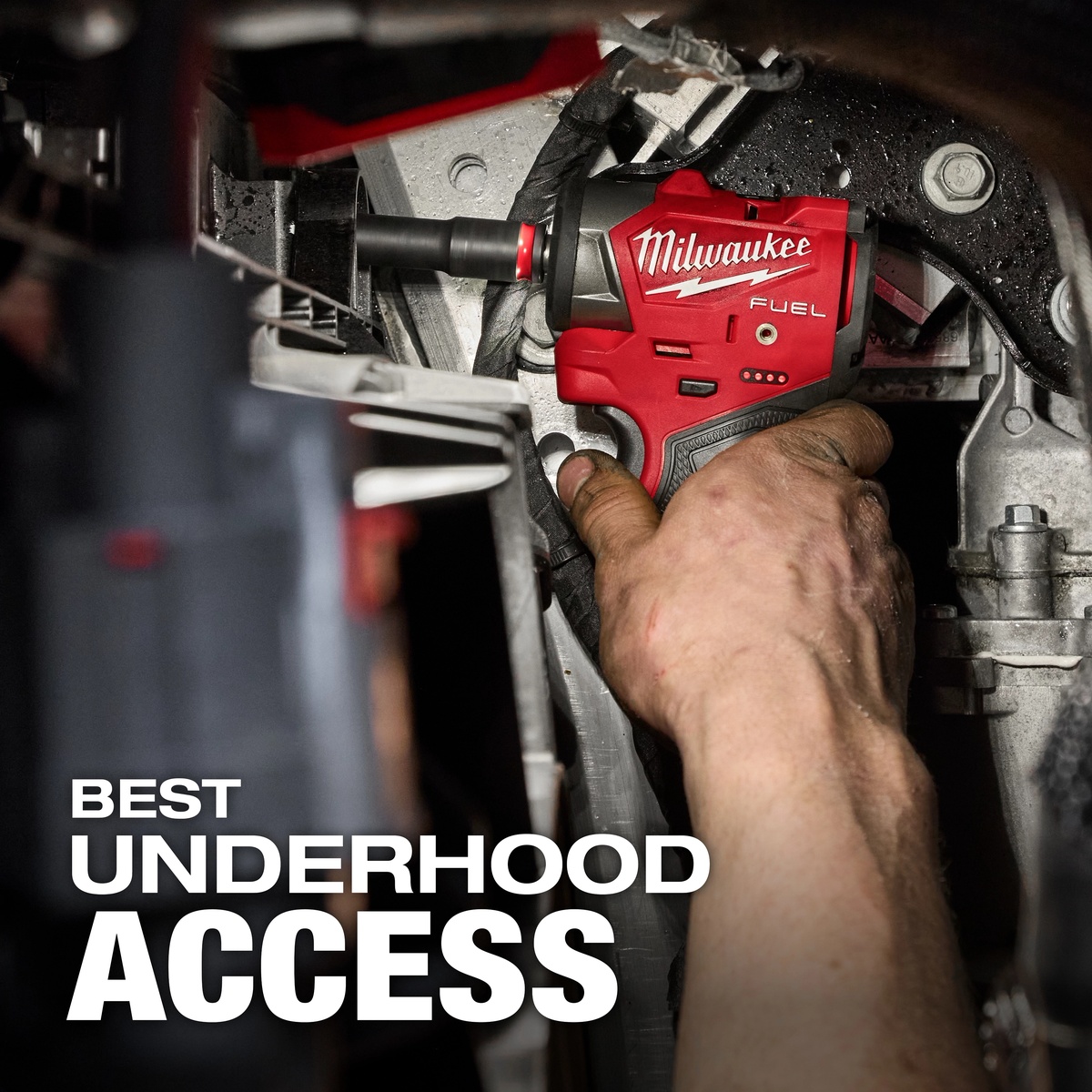 Milwaukee M12 FUEL 3/8 inch Subcompact Impact Wrench w/ Friction Ring removing a fastener under a vehicle hood in a tight engine bay