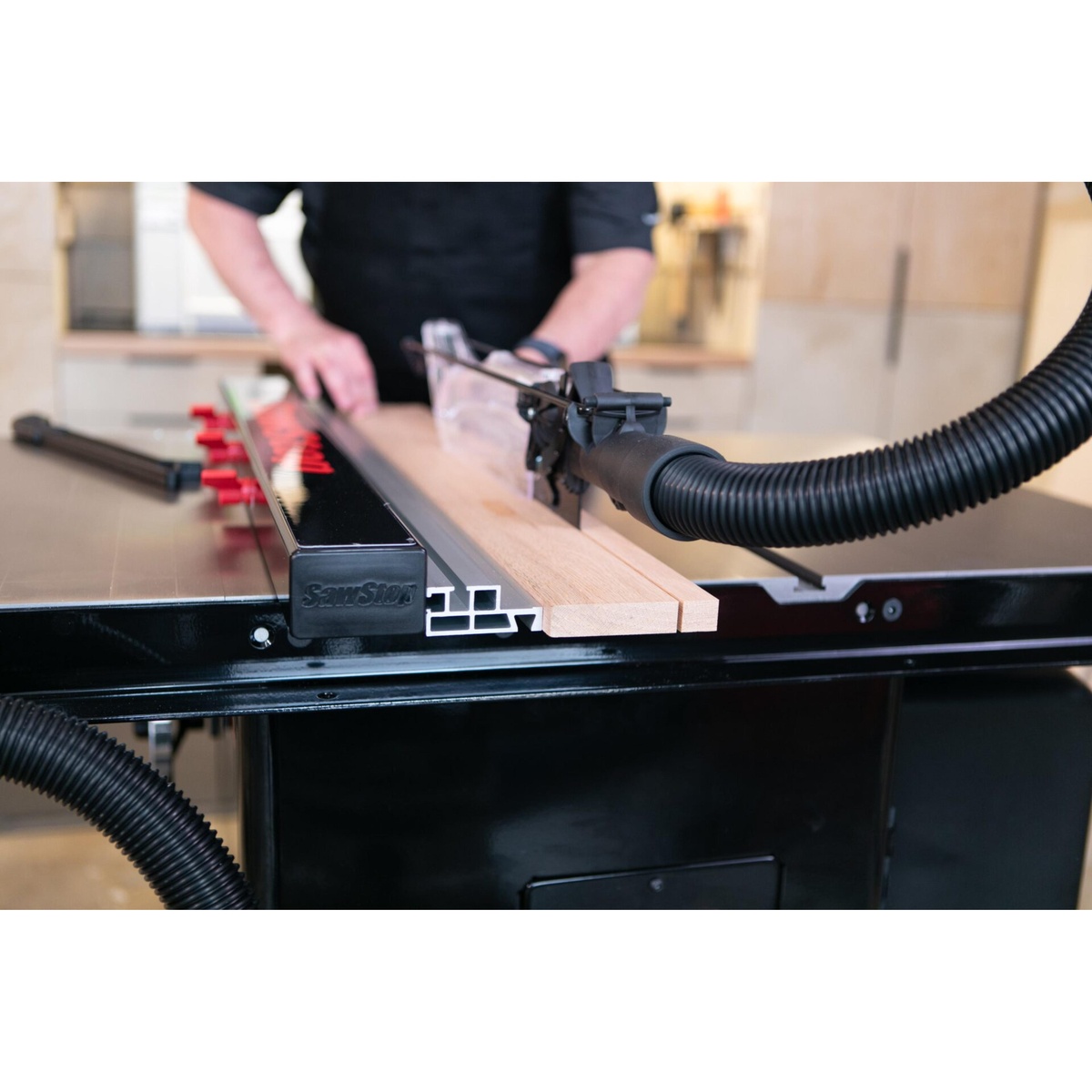 SawStop ATGP-FA Professional T-Glide Advance Rip Fence set low beside hardwood stock on a table saw during woodworking operation