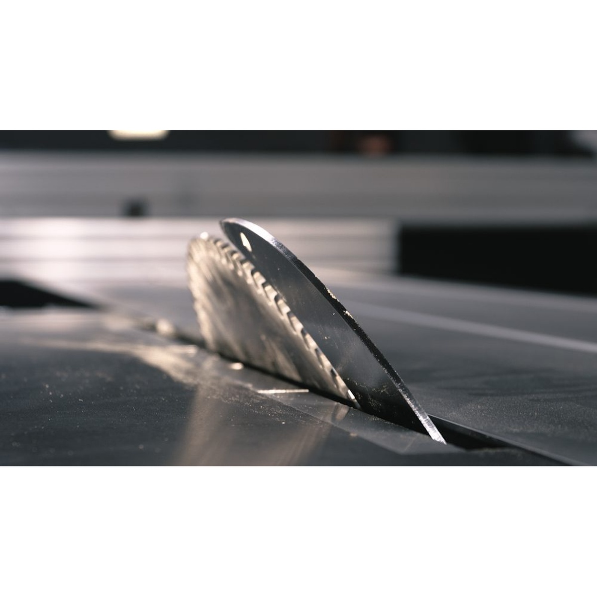 Close-up of the Maksiwa BMS.3200.IR sliding panel saw main blade rising through the table for precision woodworking cuts