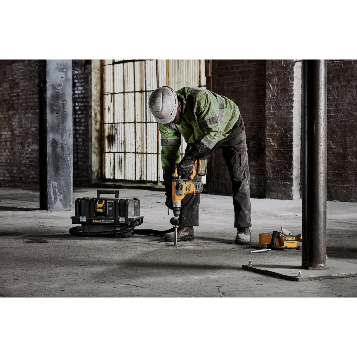 DEWALT DCH416B 60V MAX 1-1/4-in. Brushless Cordless SDS PLUS Rotary Hammer used for vertical concrete drilling on a warehouse floor during anchor installation