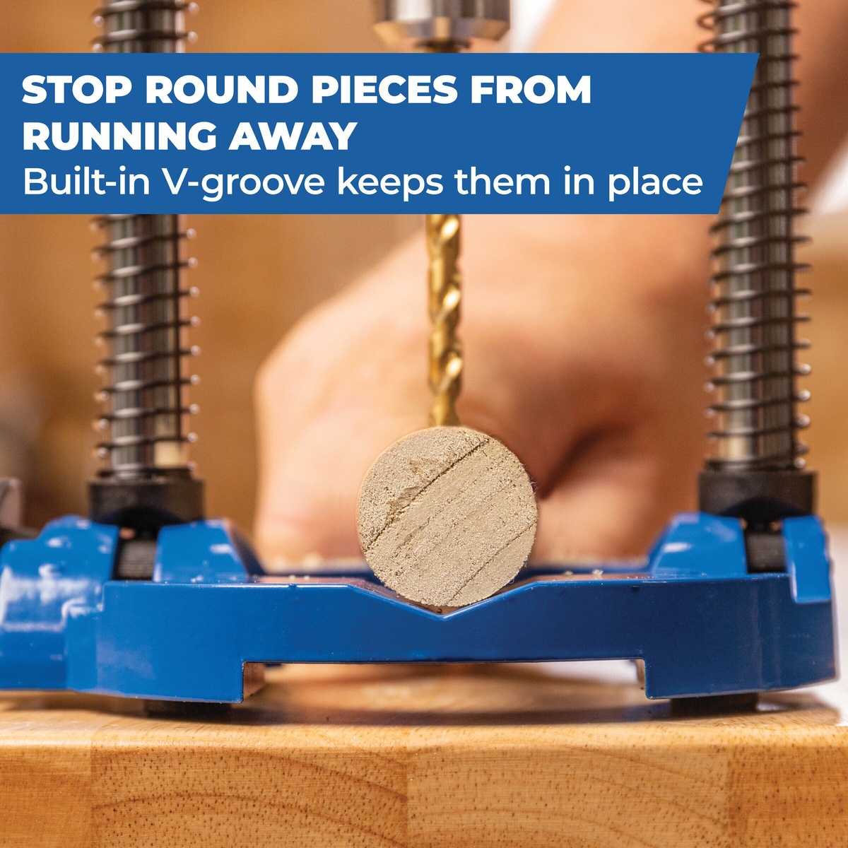 Kreg Tool KDG6500 drilling guide holding a round wood dowel in its V-groove while drilling on a woodworking bench