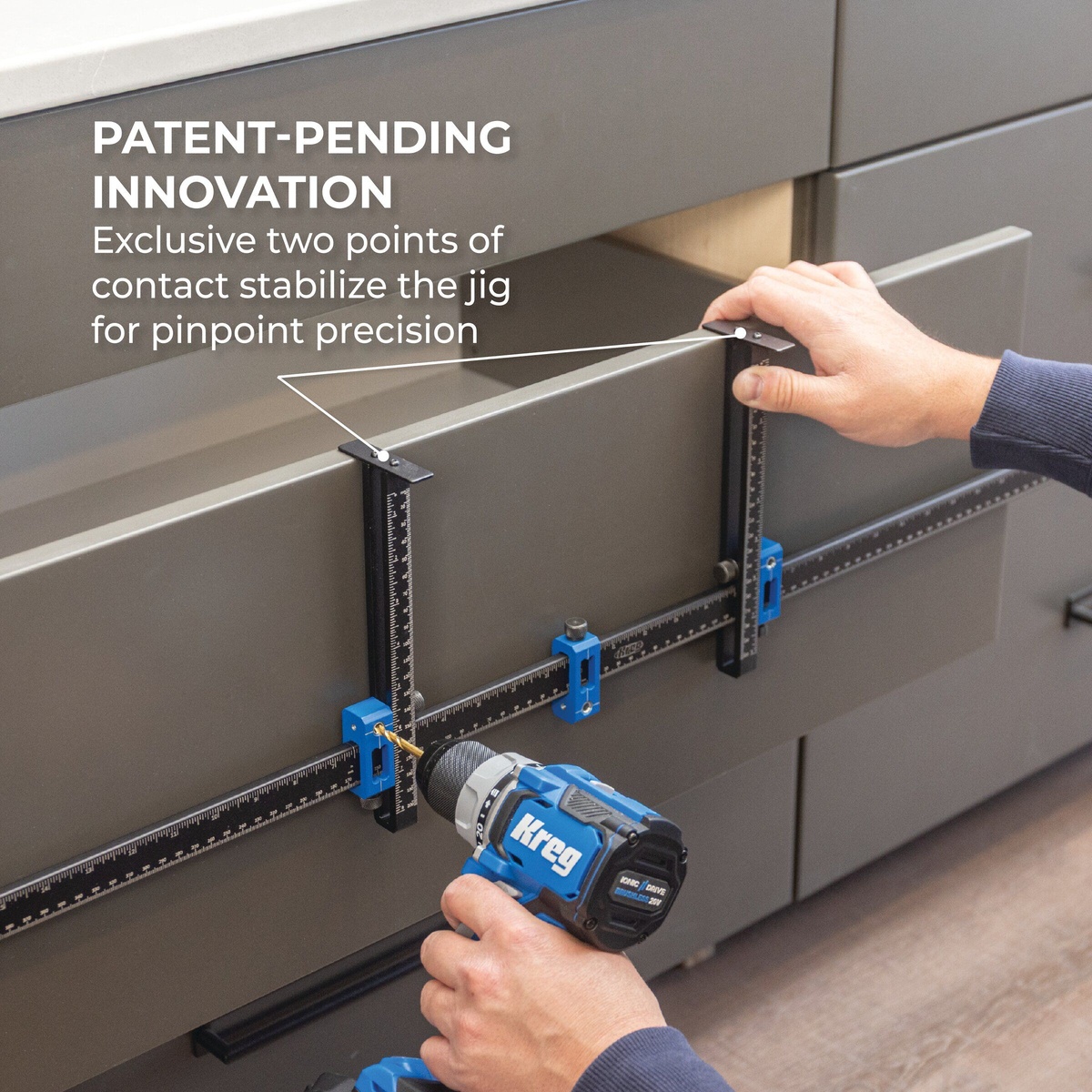 Kreg Cabinet Hardware Jig Pro XL clamped against a cabinet drawer front while drilling pull hardware holes during a finished cabinetry installation