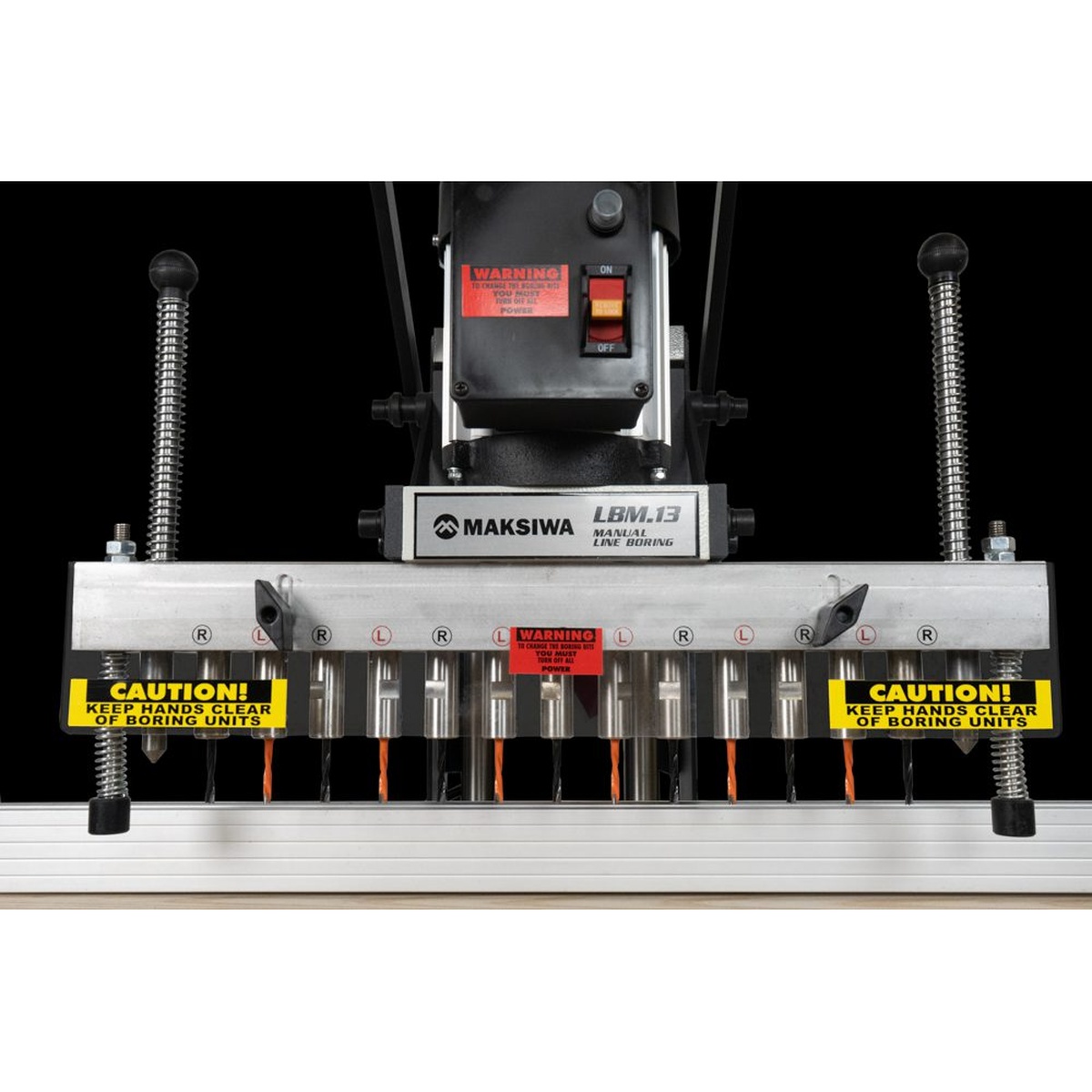 Maksiwa LBM.13 Manual Line Boring Machine spindle head and drill bits aligned for cabinet panel boring on a woodworking bench