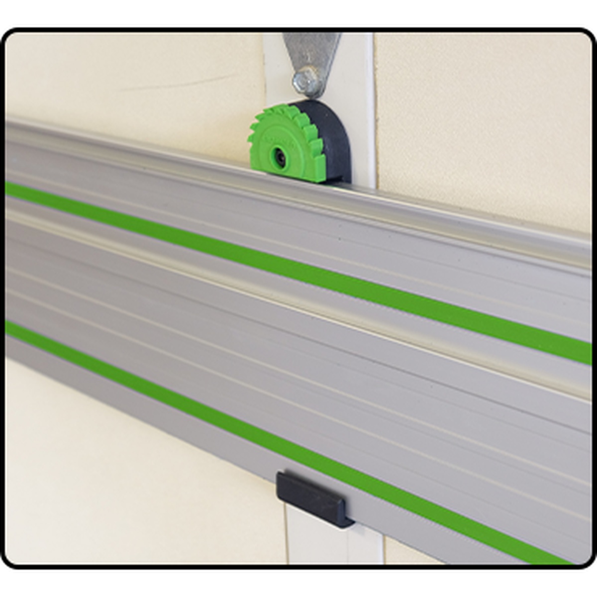 Fastcap Track Rack, 2-Pack supporting track saw guide rails on a wall for organized storage in a woodworking shop