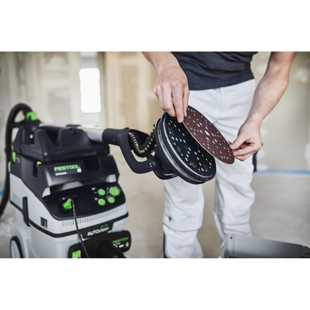 Festool 205650 Saphir Abrasive Sheets being installed on a PLANEX drywall sander during interior wall and ceiling surface prep