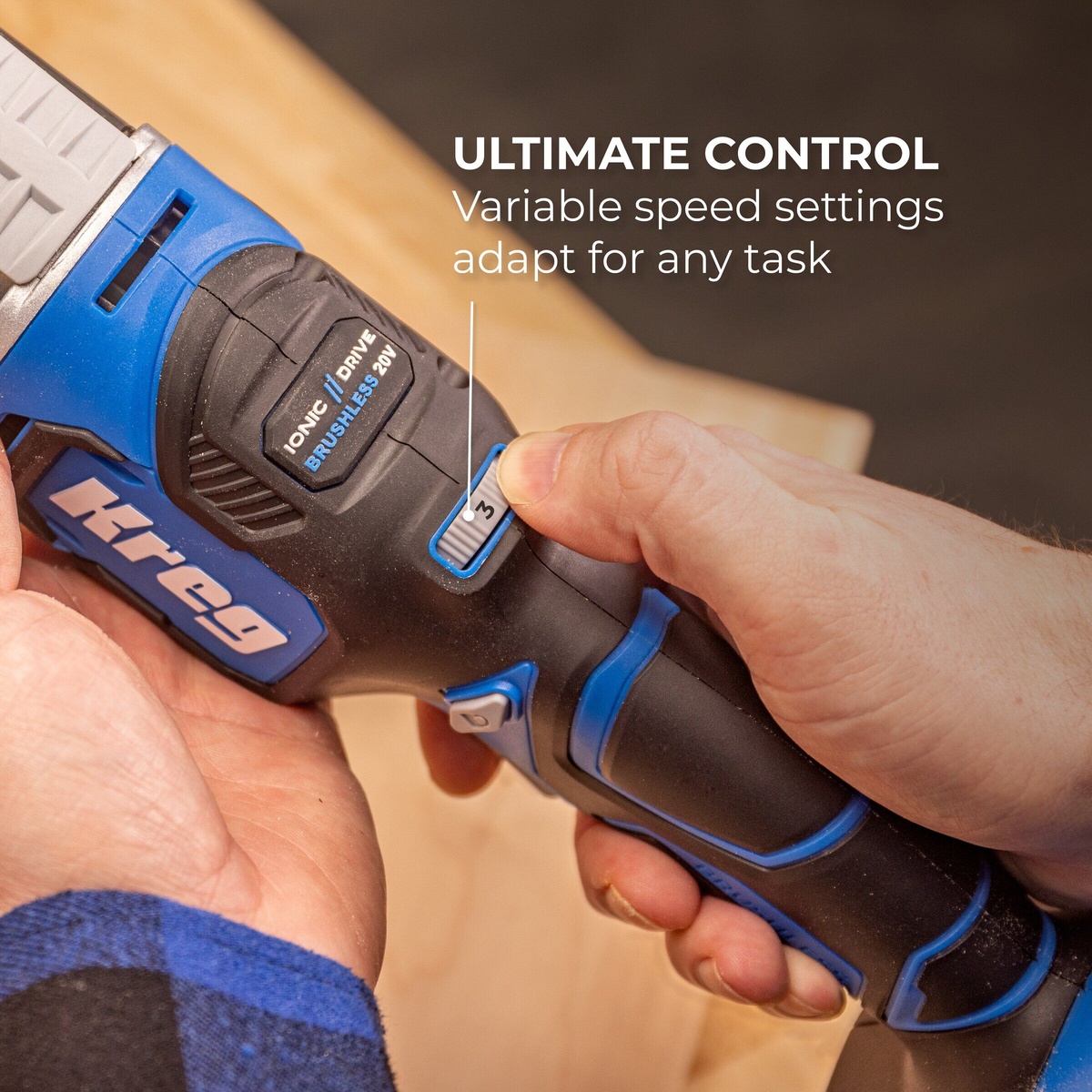 Kreg KPTMT100A oscillating multi-tool variable speed control switch being adjusted by hand for precise cutting and sanding control on a woodworking bench
