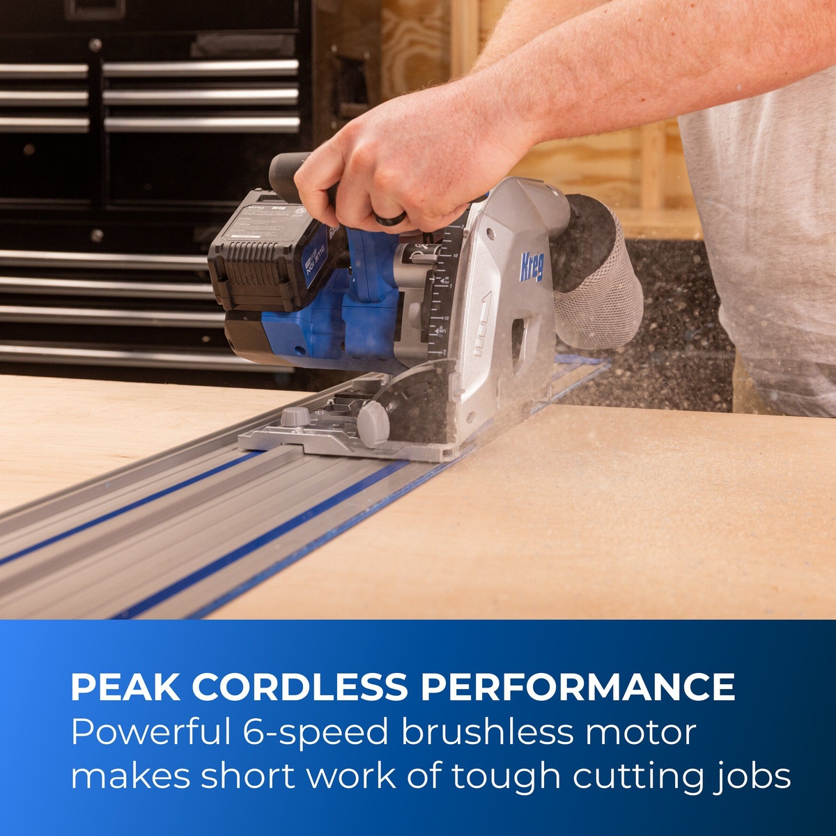 Kreg Tool KPTBPS100A cordless track saw making a guided cut through sheet material on a workbench in a shop setting