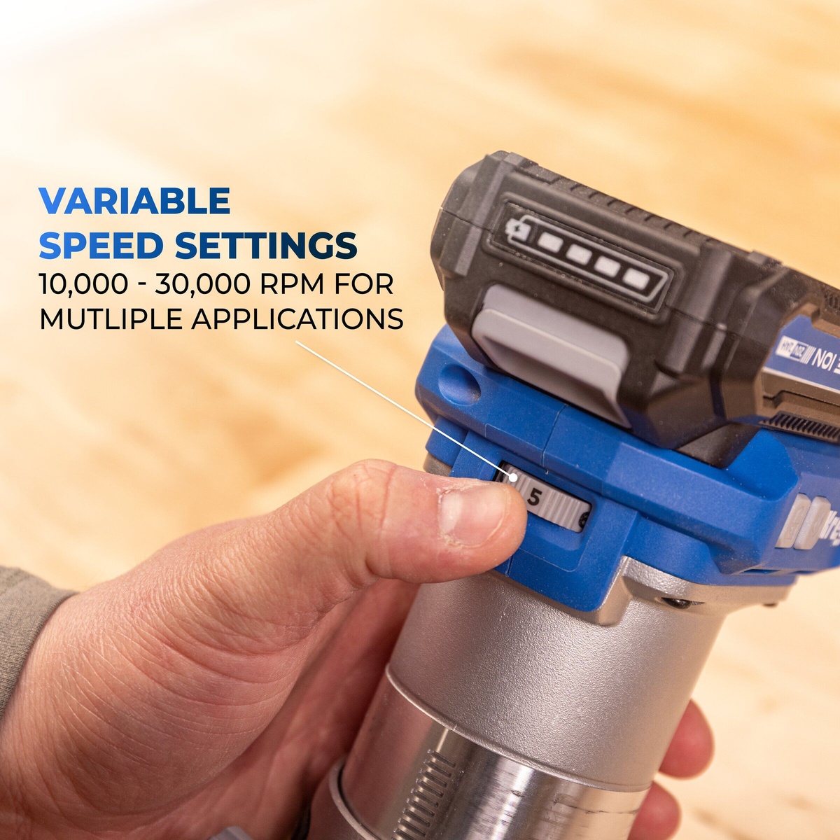 Kreg Tool KPTRT025A compact router speed dial with Kreg battery installed, shown in hand during woodworking setup for trim routing on a bench