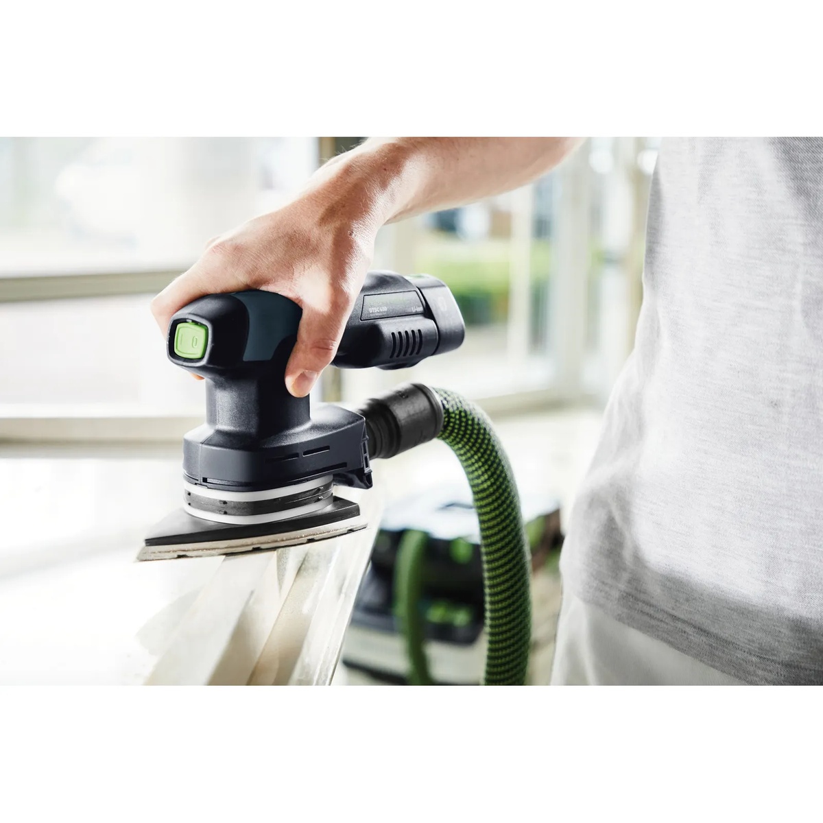 Festool Delta P180 GR/100 Granat abrasive sheet in use on painted trim with dust extraction connected during finish sanding