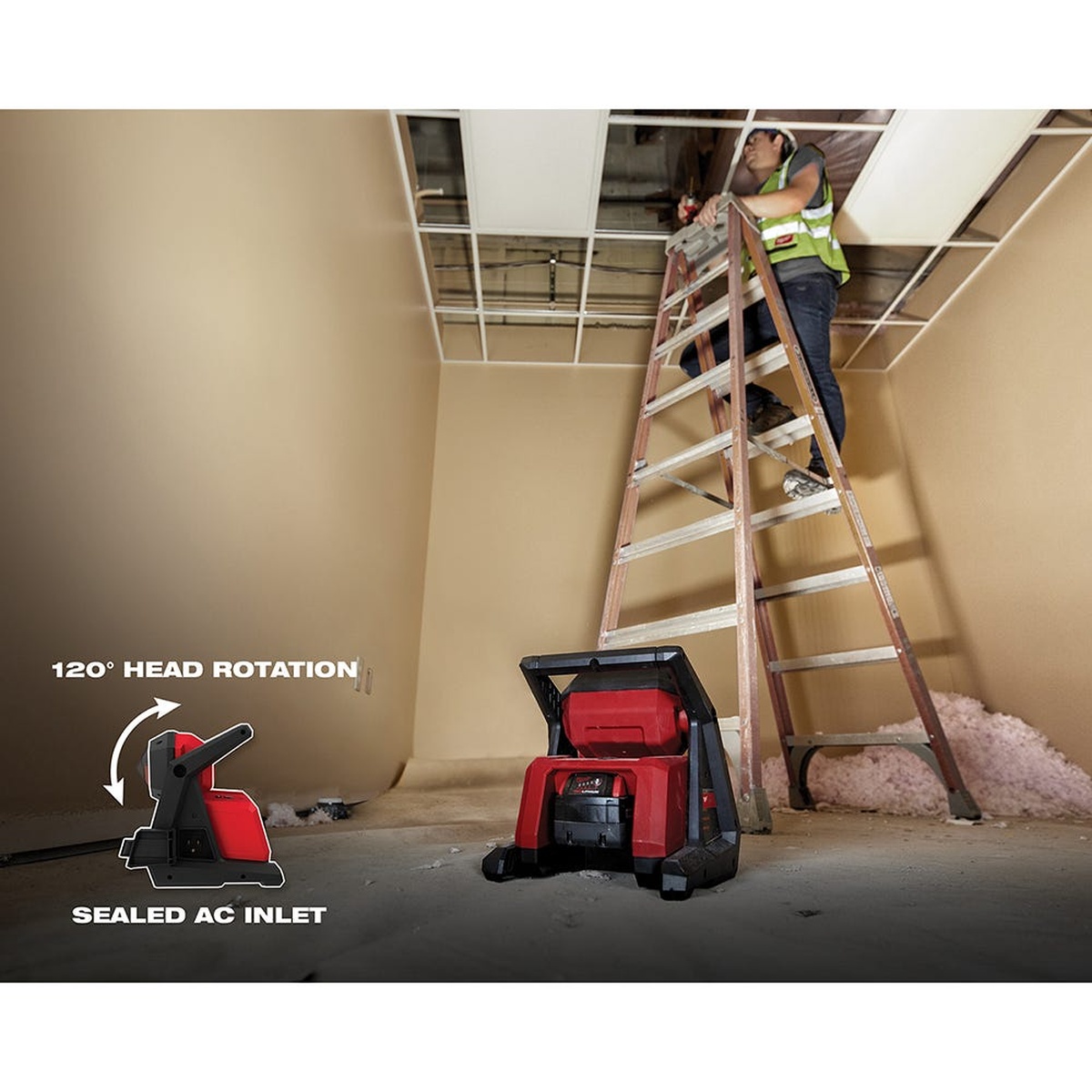 Milwaukee M18 ROVER Dual Power Flood Light + 5.0Ah Battery 2-Pack on a floor lighting a room while a worker uses a ladder to work in a drop ceiling