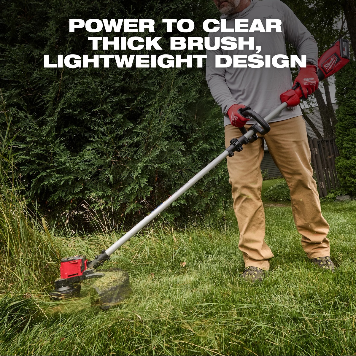 Milwaukee 2828-20E M18 Brushless String Trimmer clearing tall grass and thick brush along a residential fence line during yard cleanup