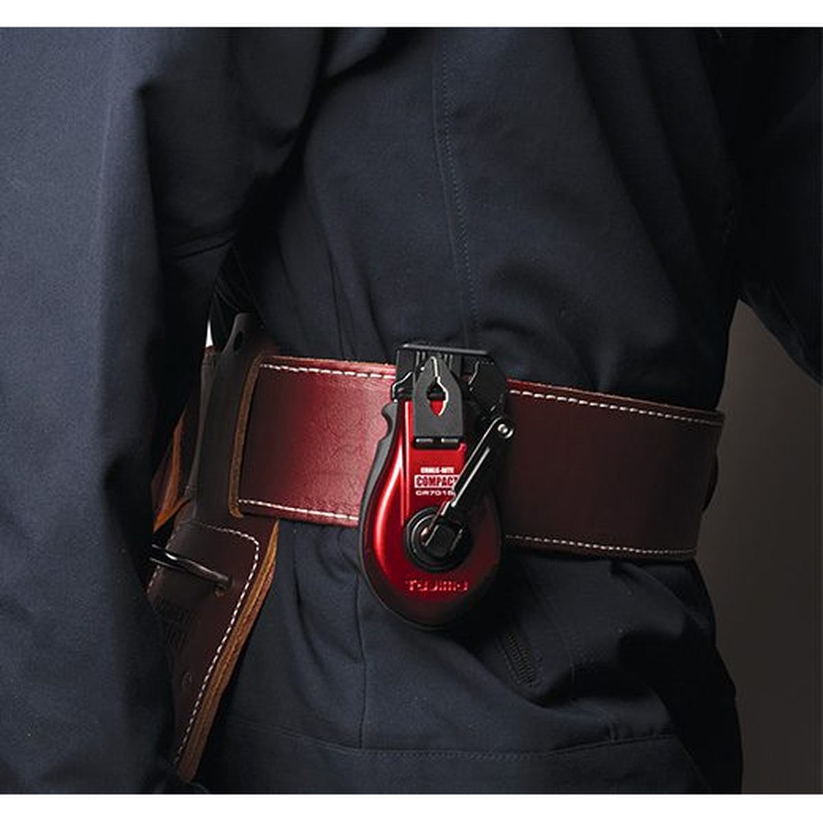 Tajima CR701SFR Chalk-Rite COMPACT Chalk Line clipped on a worker belt during construction layout work on a jobsite