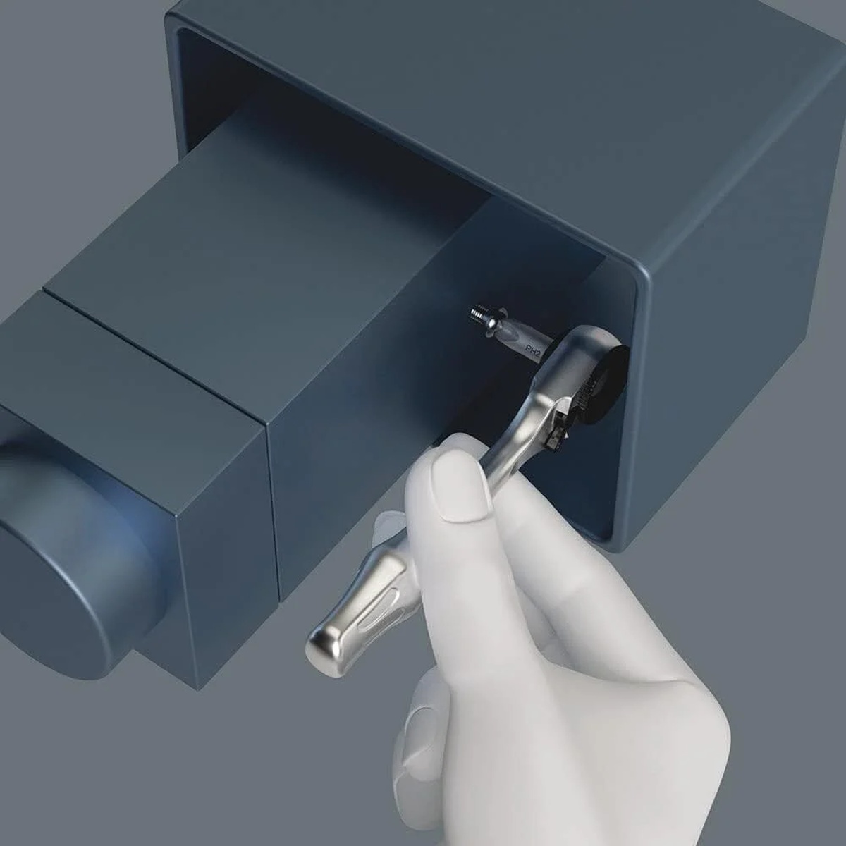 Wera Tool-Check Plus 2, 39-Pieces mini ratchet turning a fastener inside a tight metal enclosure during service work