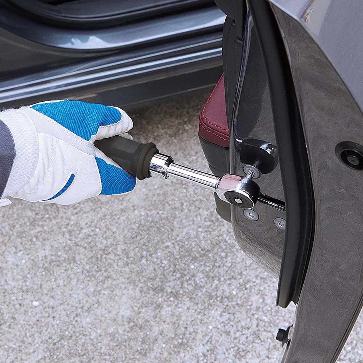 Vessel Tool e-ASSIST MINI Ratchet Wrench 400ER2U removing a fastener near a vehicle seat bracket inside a car doorway