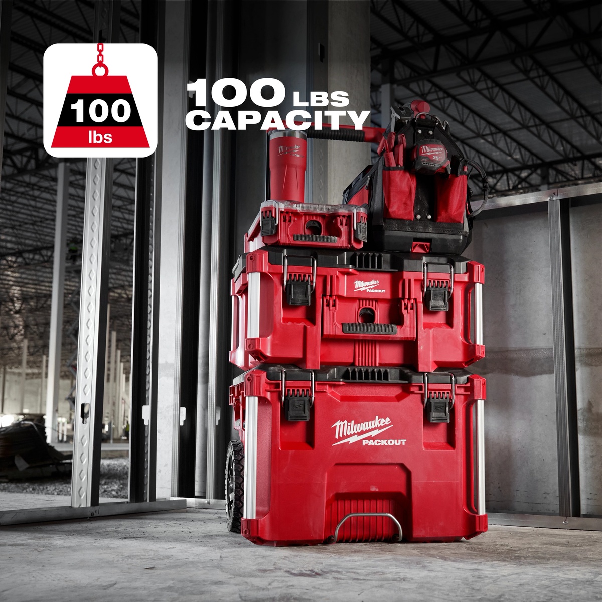 Milwaukee PACKOUT Large Tool Box 48-22-8425 stacked on a construction jobsite carrying tools and gear in a framed interior space