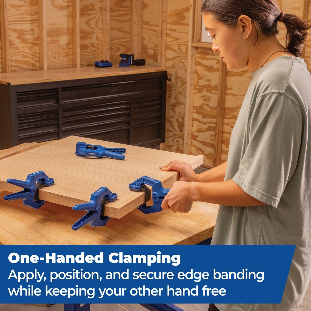 Kreg KEBC100 Edge Band Clamp used one-handed to clamp edge banding on a wood panel at a workbench