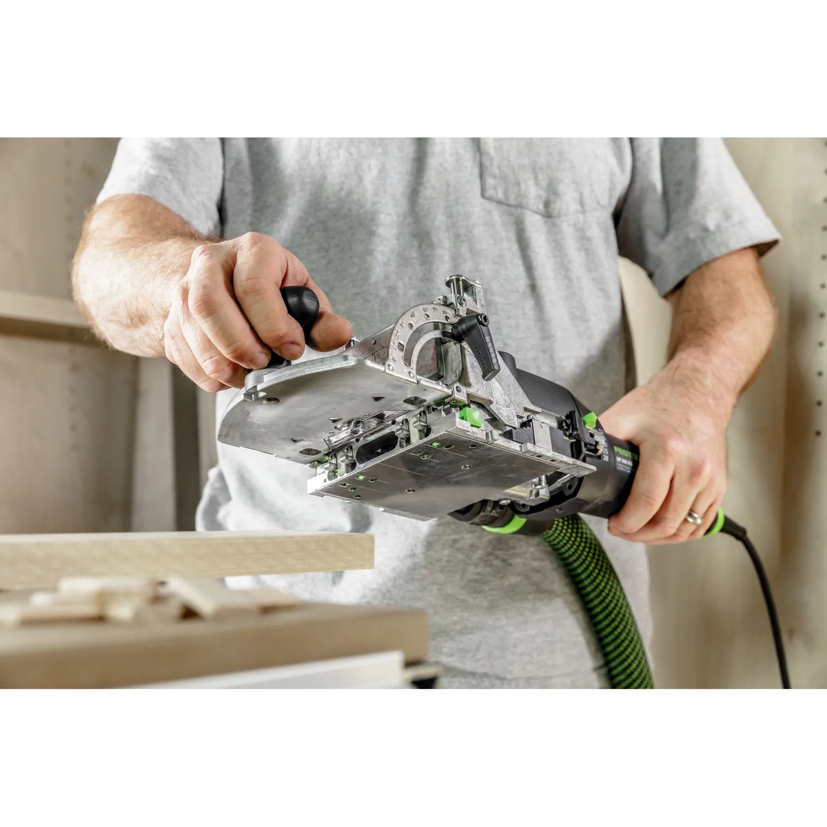 Festool 578544 Domino Joiner DF 500 RQ Set being positioned for loose tenon joinery on a woodworking bench during cabinet or furniture assembly