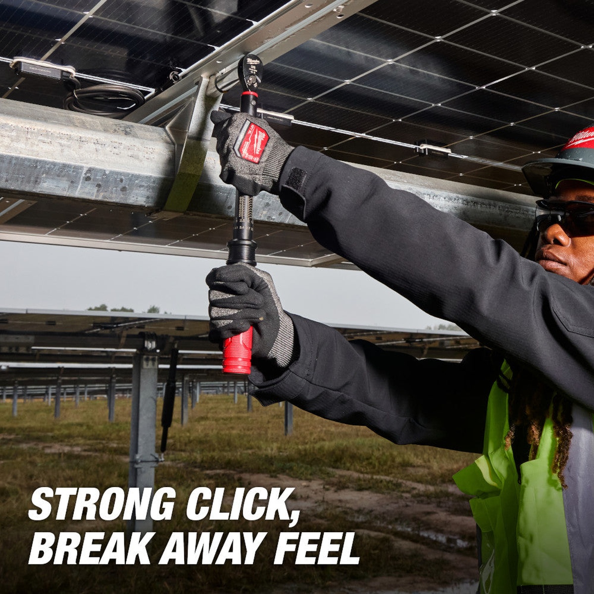Milwaukee 48-22-9201 3/8-in. Drive Click Torque Wrench being used overhead on mounted hardware in a field installation setting