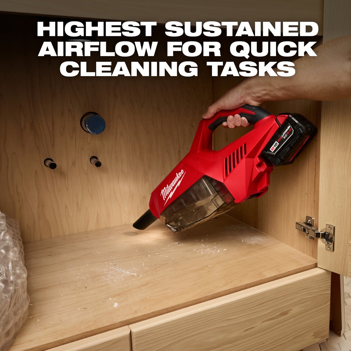 Milwaukee 0892-20 M18 Brushless Handheld Vacuum cleaning dust inside a wood cabinet during installation work in a tight indoor space