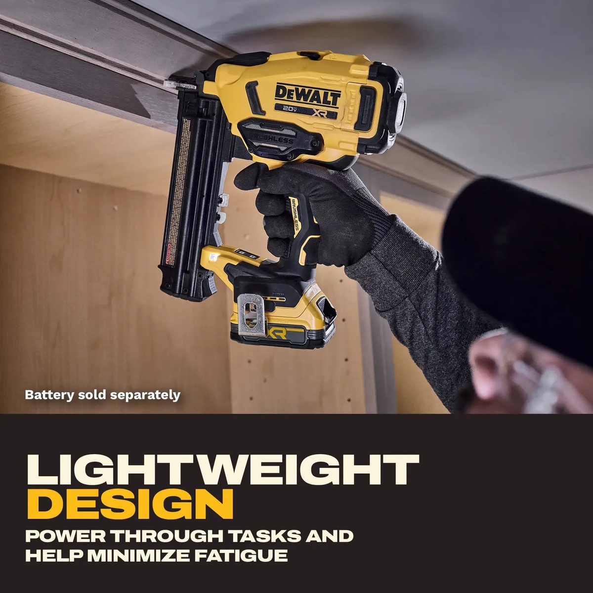 DEWALT DCN210B 20V MAX XR 18 Gauge Brad Nailer fastening trim overhead inside a cabinet installation area with the tool held one-handed in a tight interior workspace